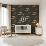 Nursery room with a crib, rocking chair, and decorative wall paper.