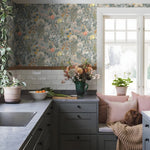 Kitchen with floral wallpaper, gray cabinets, and a window seat with pillows.