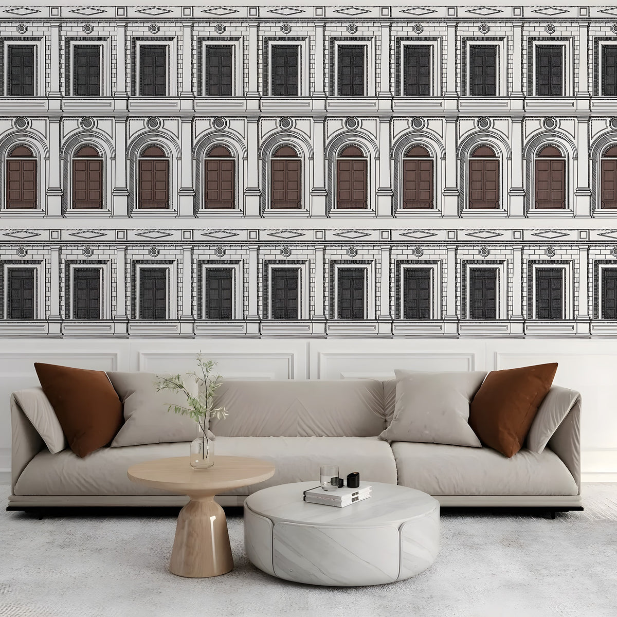 Modern living room with a sectional sofa, coffee table, and decorative pillows against a wall with architectural wallpaper.
