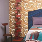 Room interior with abstract wall art and colorful bedding.