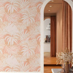 Room interior with pink and white floral wallpaper and a decorative mirror.