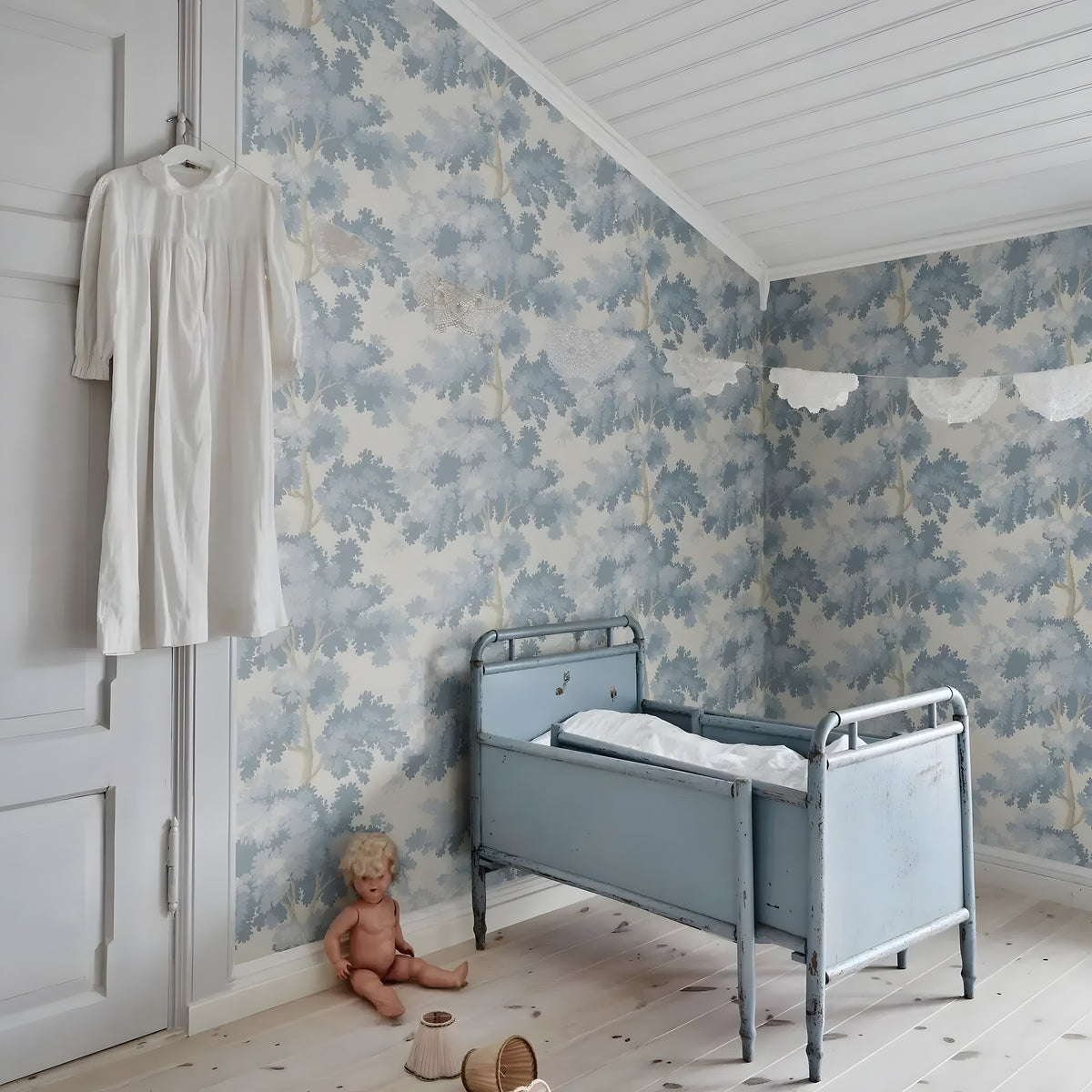 Vintage-style bedroom with floral wallpaper, a child's bed, and toys on a wooden floor.