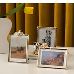 Three decorative picture frames with different designs on a surface.