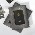 Decorative photo frame with textured surface and gold accents on a white background