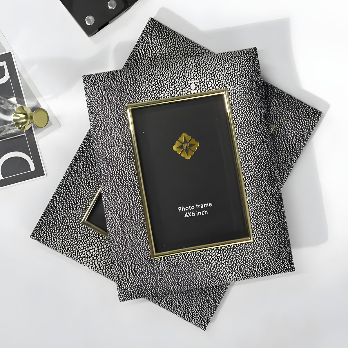 Decorative photo frame with textured surface and gold accents on a white background