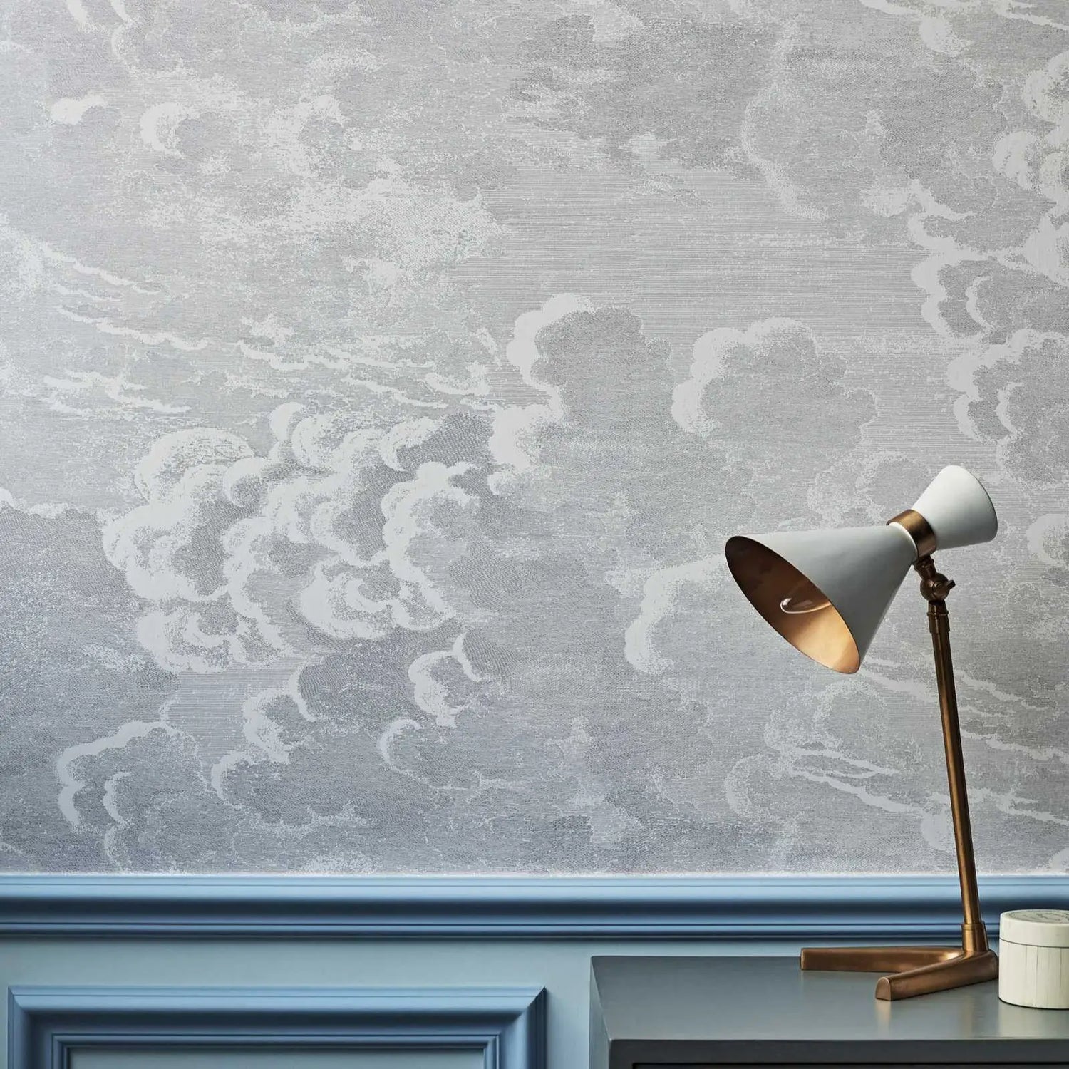 Decorative lamp on a surface with a textured gray wall in the background