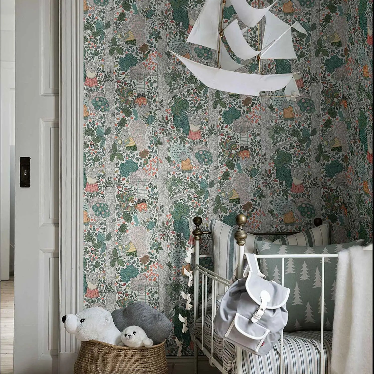 Children's room with floral wallpaper, crib, and decorative elements.