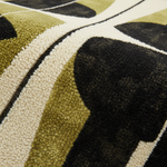 Close-up of a patterned rug with black, green, and beige colors.