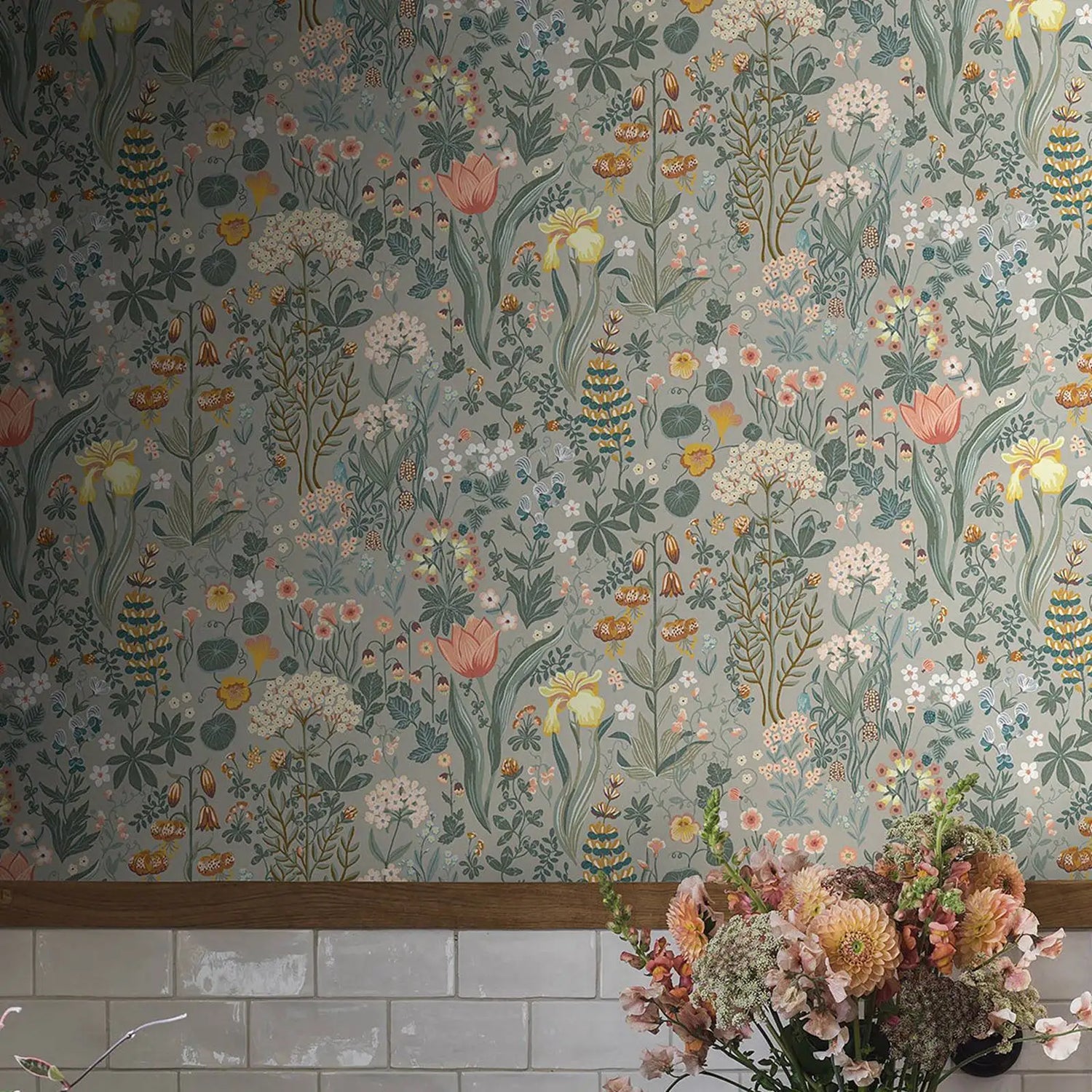 Floral wallpaper with a bouquet of flowers in the foreground on a tiled wall.