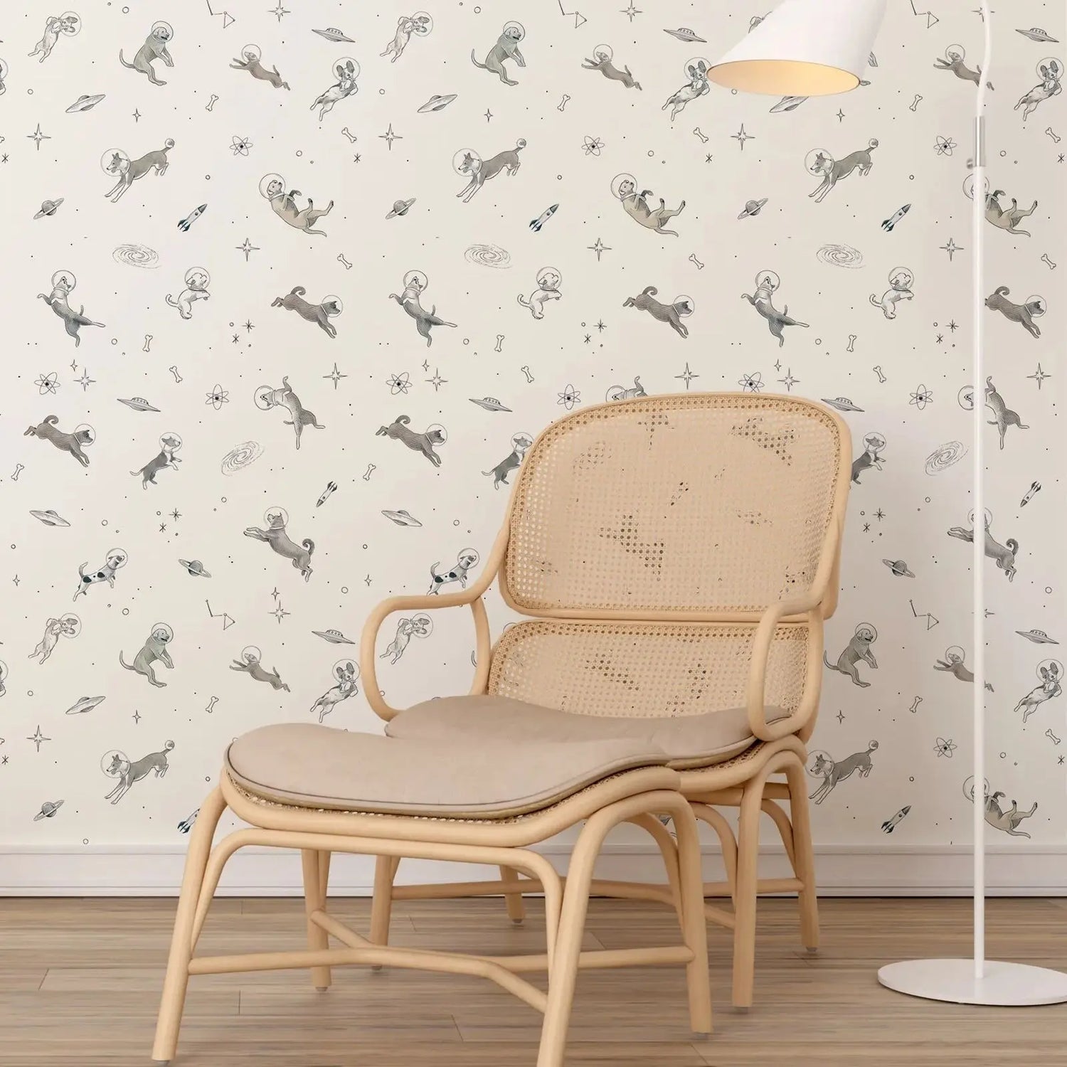 Beige wicker chair with cushion against a wall with dog-themed wallpaper