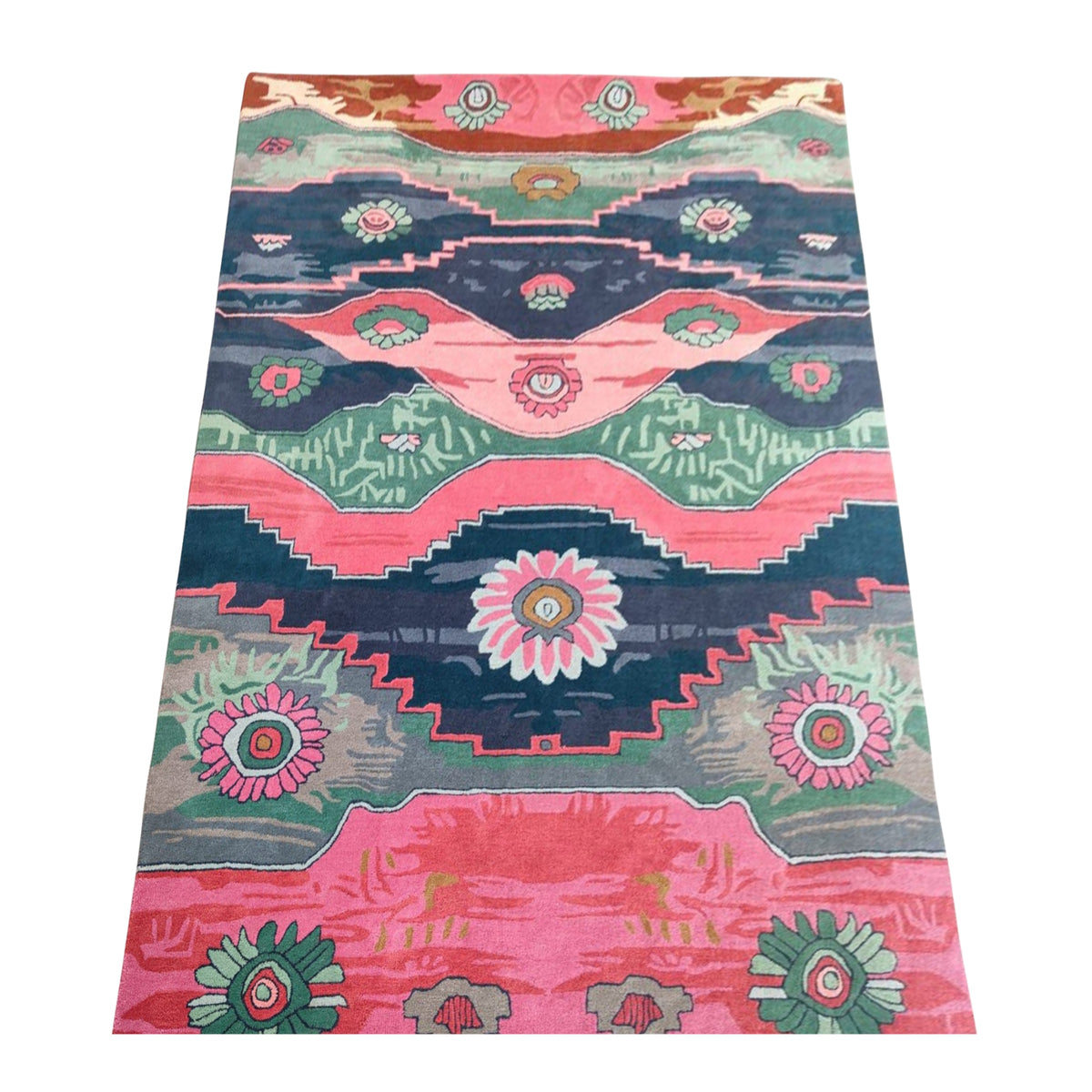Colorful hand-tufted rug featuring Aztec geometric designs and floral medallions in shades of pink, teal, green, and dark blue.