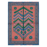 A rectangular woven rug with a coral pink field, blue and green geometric zigzag patterns, and a blue border with fringe on the top and bottom edges.