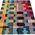 Multicolored geometric patterned rug on a white background