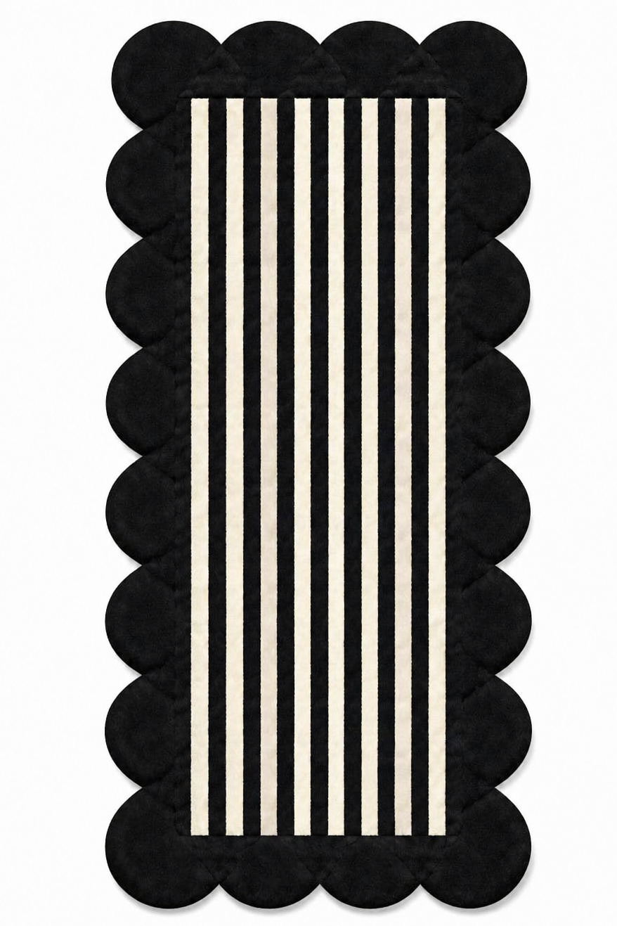 Rectangular rug with scalloped black border and vertical white stripes 