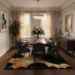 Modern dining room with a round table, chairs, and decorative elements.