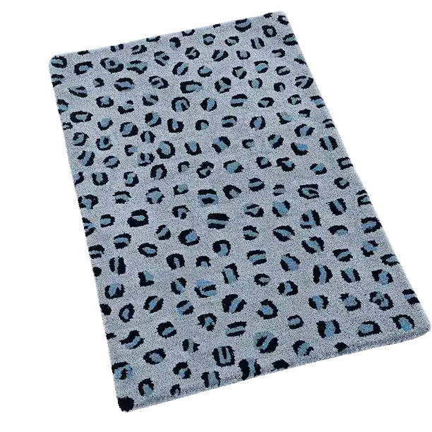 A stylish area rug featuring a blue leopard print pattern, perfect for adding a modern touch to large living rooms. This hand-tufted wool rug combines bold design with cozy comfort, ideal for enhancing any living room space.