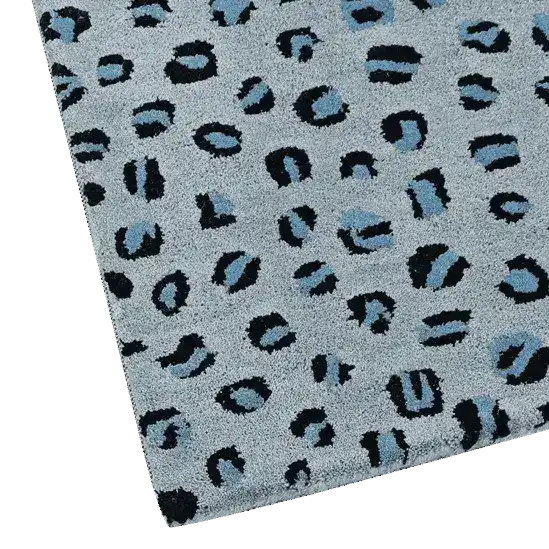 Close-up view of a blue leopard print hand tufted wool area rug, perfect for large living room spaces. The intricate design features bold black and blue patterns on a soft grey background, highlighting the luxurious texture of this living room wool rug.