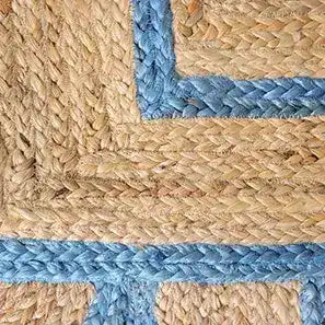 Close-up of a Blue Scalloped Border Jute Rug, showcasing intricate braided patterns with natural jute tones and a blue scalloped edge. Perfect as an area rug for the hallway, kitchen, bedroom, bathroom, or dining room, adding a touch of natural elegance.