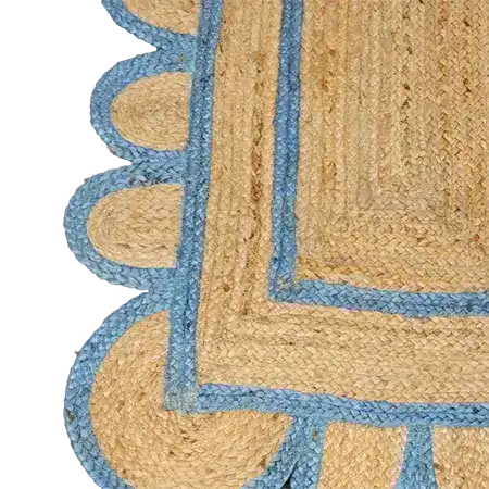 Close-up of a Blue Scalloped Border Jute Rug Runner, showcasing its intricate woven pattern. This versatile area rug is perfect for use as a hallway runner rug, kitchen rug, or bedroom rug. The natural jute material and elegant blue scalloped edges make it an ideal addition to any dining room or bathroom decor.