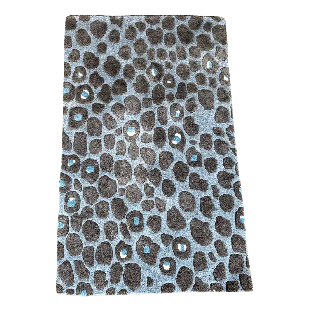 Stylish blue and black leopard print area rug, perfect for adding a touch of luxury to your bedroom or living room. This hand-tufted wool rug features a captivating pattern ideal for large spaces, making it a standout piece among bedroom rugs or large area rugs.