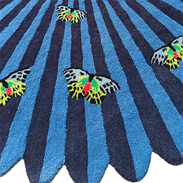 A vibrant blue and black hand-tufted wool area rug featuring colorful butterfly designs, perfect for adding a touch of nature to your bedroom or living room. This round rug is an ideal choice for those looking for large area rugs to enhance their home decor.