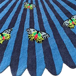 A vibrant blue and black hand-tufted wool area rug featuring colorful butterfly designs, perfect for adding a touch of nature to your bedroom or living room. This round rug is an ideal choice for those looking for large area rugs to enhance their home decor.