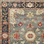 Close-up view of the Charming Floral Cascade Hand Knotted Area Rug, showcasing intricate floral patterns and vibrant colors with a traditional border design.