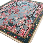 Beautiful Cherry Grove Serenity hand-tufted area rug perfect for a living room, featuring an intricate floral design with pink and red cherry blossoms against a soft blue background. This wool rug adds elegance and color, making it an ideal choice for large living room rugs.