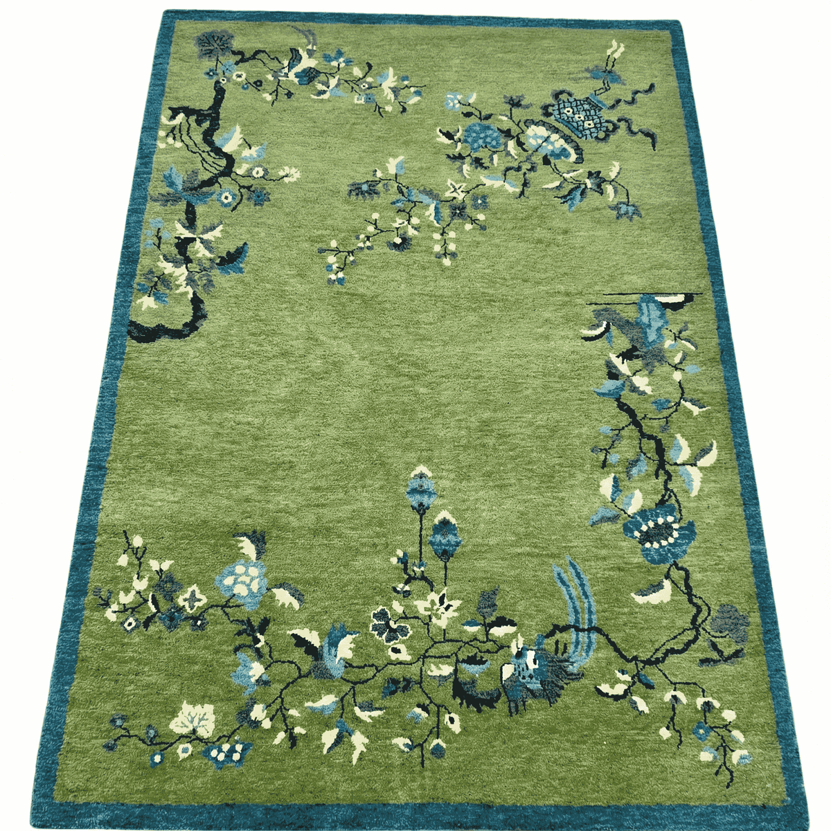 Green rug with floral patterns on a white background