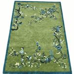 Green rug with floral patterns on a white background