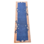 Blue runner with floral patterns on a beige border on a white background