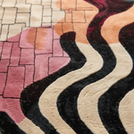Close-up of a textured rug with wavy pattern and multicolor design