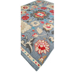 Floral patterned rug with colorful flowers on a blue background