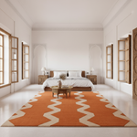 Modern bedroom with a large orange and beige zigzag patterned rug.