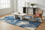 Living room with a blue and white patterned rug, wooden chair, and coffee table.