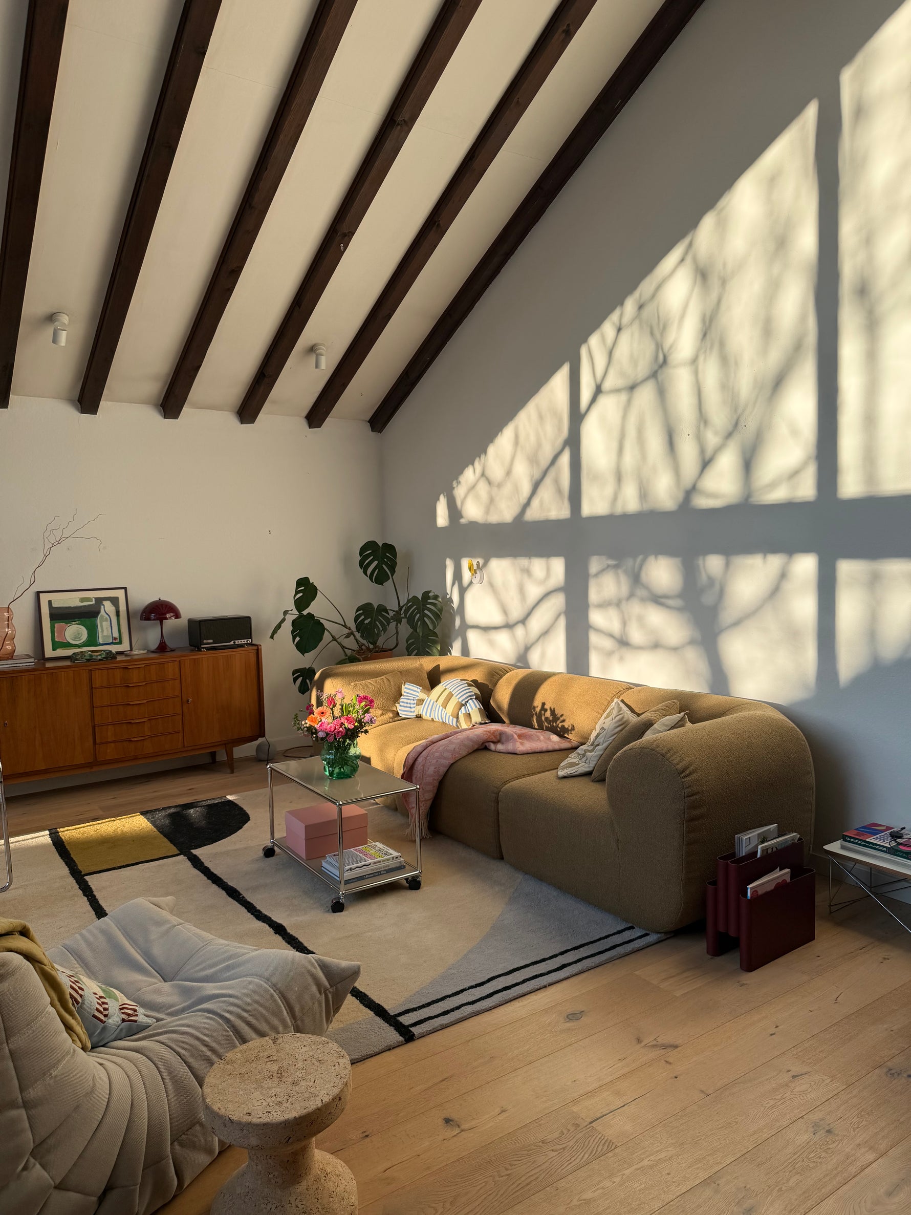 Top-down view of a living room with a  rug, couch, coffee table, and decorative items.