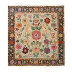 Vibrant and colorful hand-knotted area rug featuring a rich floral pattern with a variety of flowers in bold hues. The intricate design is bordered by a dark frame, enhancing the beauty of this elegant rug.