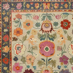 A vibrant, hand-knotted area rug featuring a colorful floral design, perfect for adding a touch of vintage elegance to your living room. This Persian-style rug showcases intricate patterns with blooming flowers in rich, warm colors, ideal for those seeking unique rugs for living room decor.