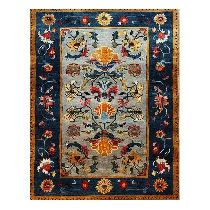 A vibrant and colorful carnival hand-tufted wool rug, perfect as a large area rug for living rooms. This beautiful wool rug features intricate floral and abstract patterns in rich hues of blue, orange, yellow, and red, making it an ideal choice for adding warmth and style to any living room.