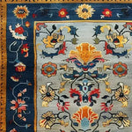 Vibrant and colorful wool area rug featuring an intricate floral pattern with bold hues of blue, yellow, and red, perfect for enhancing large living room spaces. The detailed design of this hand tufted wool rug adds a touch of elegance to any living room area, making it an ideal choice for those seeking stylish area rugs for living room decor.