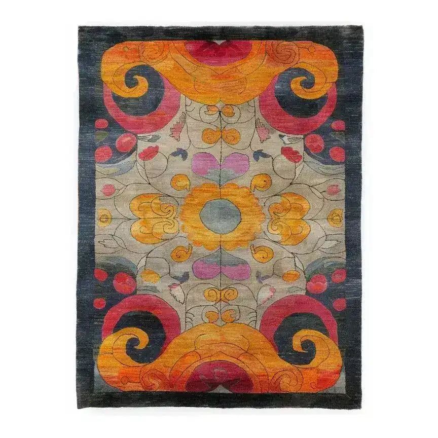 Vibrant and colorful hand-knotted area rug featuring an intricate kaleidoscope pattern with swirling designs in shades of orange, red, and dark blue. The central motif draws attention with its symmetrical floral elements, creating a captivating focal point. Perfect for adding a splash of color and artistry to any room.