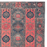 A beautifully crafted area rug featuring a vintage design with intricate floral patterns in shades of crimson and navy. This large living room rug is made from high-quality wool, adding a touch of elegance and warmth to any space.