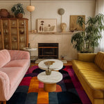 A beautifully styled living room featuring a Crimson Curve Hand Tufted Wool Rug, perfect for large living rooms. The vibrant area rug, in shades of crimson, orange, and navy, adds a touch of elegance to the cozy space, complemented by plush sofas and chic decor. Ideal for an office or living room, this 8x10 wool rug enhances the room’s aesthetic with its bold design.