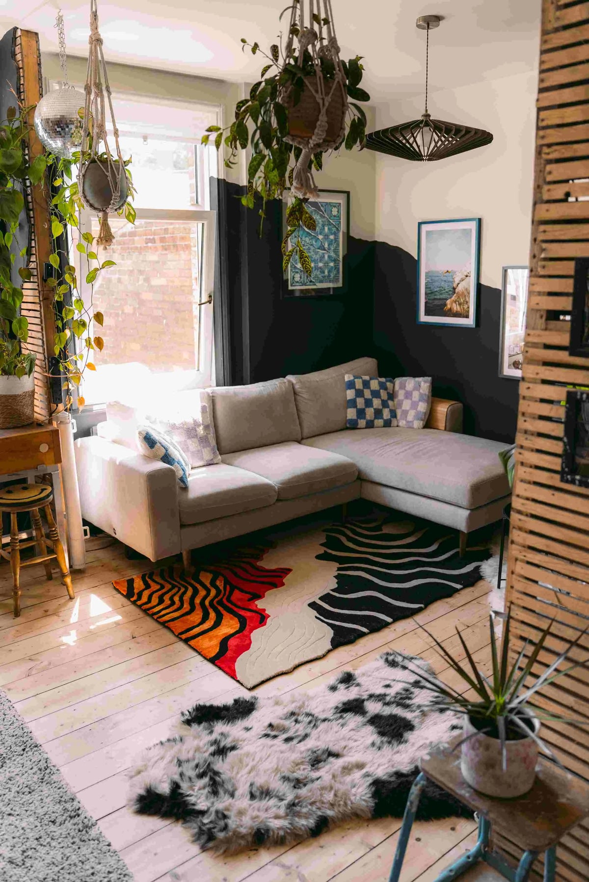 A cozy living room featuring a contemporary area rug with a vibrant curved line design. The wool rug adds a splash of color and texture, complementing the neutral sectional sofa and enhancing the modern aesthetic of the space. Perfect for those looking for stylish area rugs for the living room.