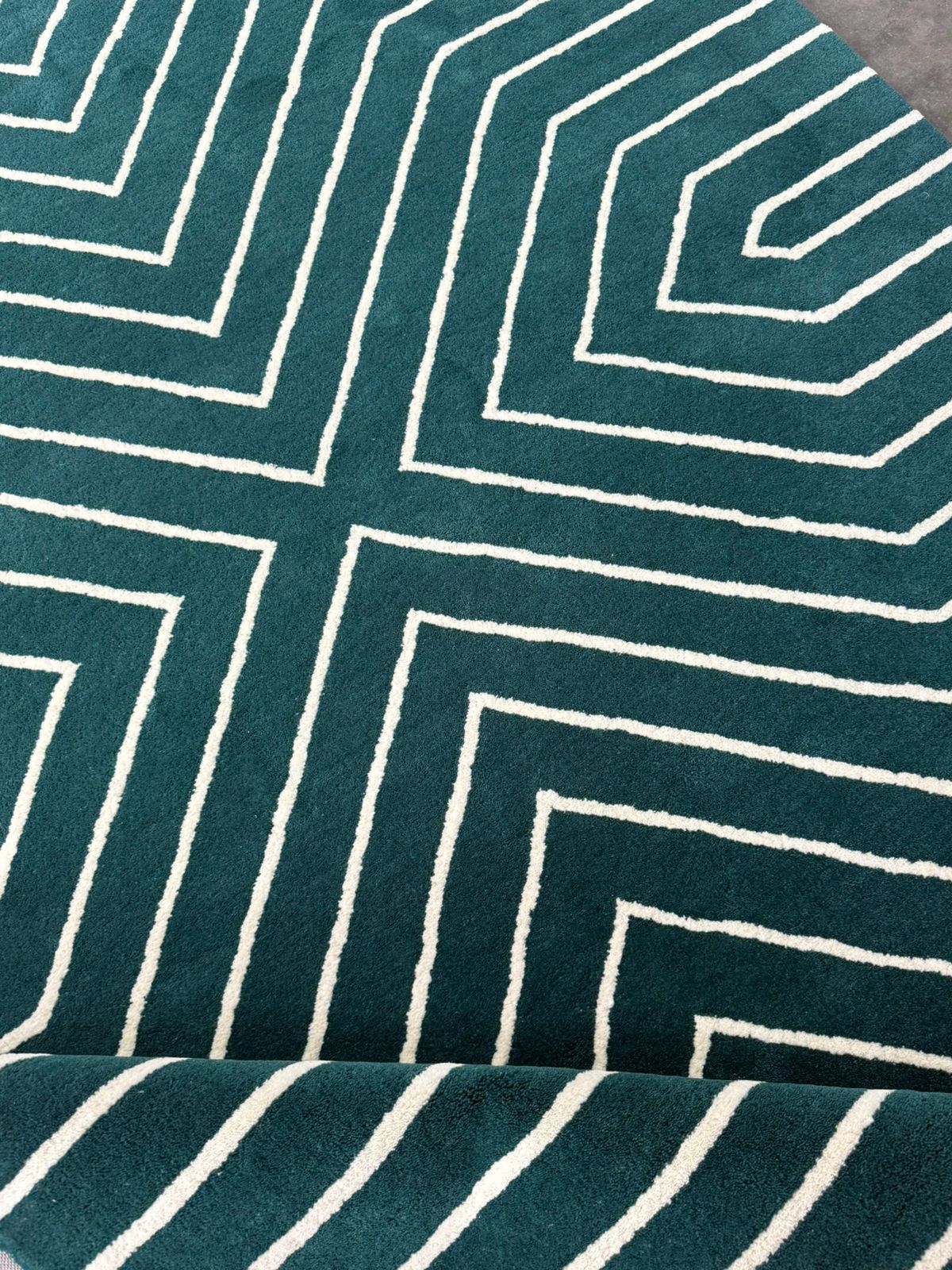 Teal fabric with white geometric pattern