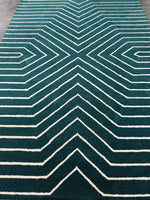 Teal rug with white geometric pattern