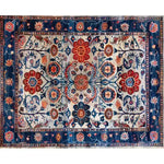 A beautifully intricate Dreamy Floral Escape hand-knotted wool rug featuring a vintage Persian design. The area rug displays an array of vibrant floral patterns in shades of red, blue, and orange, making it an ideal choice for dining room carpets or a living room centerpiece. This floral rug captures the essence of traditional Persian rugs, perfect for adding a touch of elegance to any space.