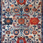 A beautifully detailed hand-knotted wool area rug showcasing an intricate floral design with rich red, blue, and orange hues. Perfect for adding a vintage charm to your living room or dining room. This floral rug captures the essence of Persian rugs, making it an ideal choice for those seeking elegant area rugs for living room or dining room carpets.