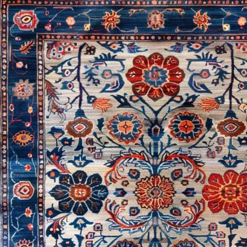 Close-up view of the Dreamy Floral Escape hand-knotted wool rug, featuring vibrant floral patterns in rich blue, red, and orange hues. This vintage-inspired area rug is perfect for enhancing the elegance of living rooms and dining rooms. The intricate design is reminiscent of traditional Persian rugs, making it a stunning choice for anyone seeking a luxurious wool rug.