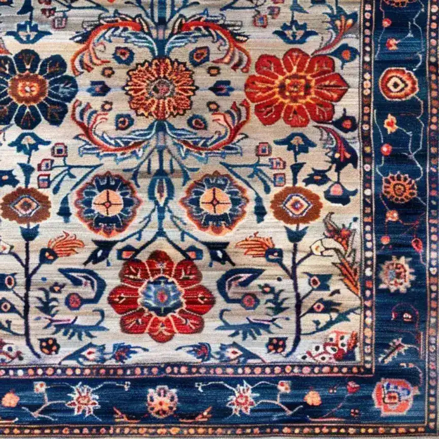 Close-up view of a Dreamy Floral Escape hand-knotted wool area rug featuring intricate vintage floral patterns in vibrant reds, blues, and earth tones. This elegant Persian-style rug is perfect for enhancing the aesthetics of living room and dining room spaces.